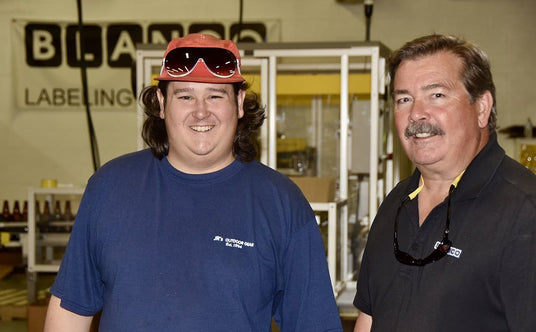 Picture of Nate Webber in warehouse with Kurt